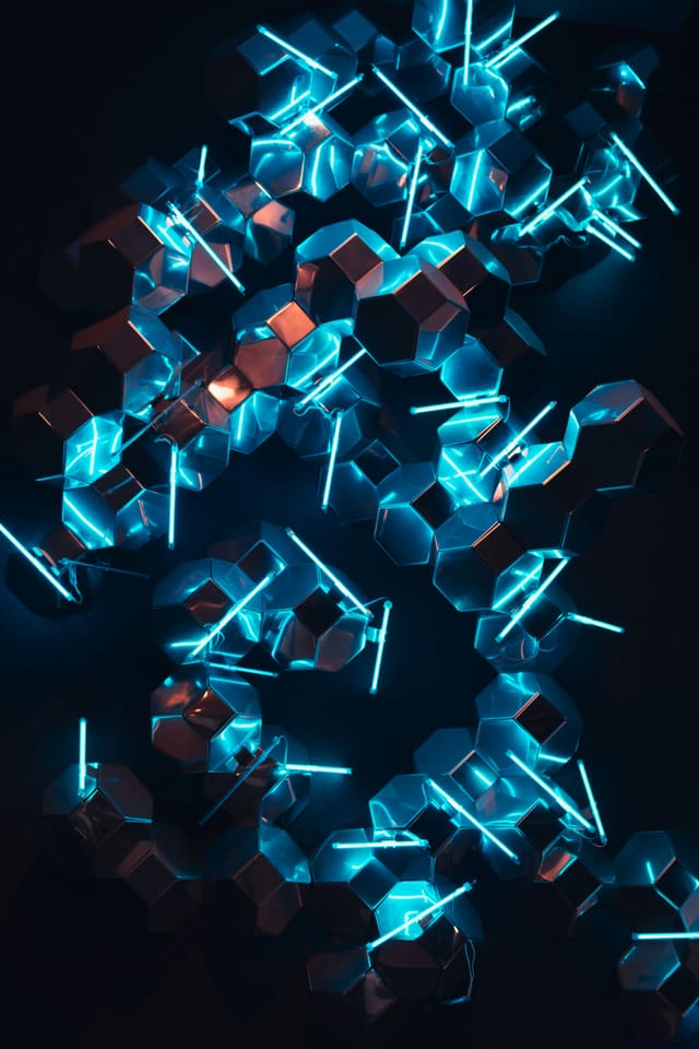 Metallic hexagonal blocks locked together and lit by blue neon rods